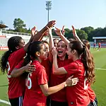 A diverse sports team celebrating victory together